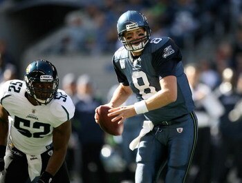SEATTLE - OCTOBER 11:  Quarterback Matt Hasselbeck #8 of the Seattle Seahawks scrambles against linebacker Daryl Smith #52 of the Jacksonville Jaguars on October 11, 2009 at Qwest Field in Seattle, Washington. The Seahawks defeated the Jaguars 41-0. (Phot