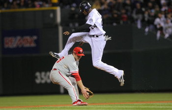 DENVER - OCTOBER 12: Dexter Fowler #24 of the Colorado Rockies hurdles safely over Chase Utley #26 the Philadelphia Phillies in Game Four of the NLDS during the 2009 MLB Playoffs at Coors Field on October 12, 2009 in Denver, Colorado. (Photo by Doug Pen