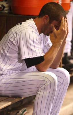 DENVER - OCTOBER 12: Huston Street #16 of the Colorado Rockies sits dejected in the dugout against the Philadelphia Phillies in Game Four of the NLDS during the 2009 MLB Playoffs at Coors Field on October 12, 2009 in Denver, Colorado. (Photo by Jed Jacobs