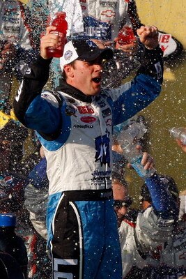 FONTANA, CA - OCTOBER 11:  Jimmie Johnson, driver of the #48 Lowe's Chevrolet, celebrates in victory lane after winning the NASCAR Sprint Cup Series Pepsi 500 at Auto Club Speedway on October 11, 2009 in Fontana, California.  (Photo by Chris Graythen/Gett