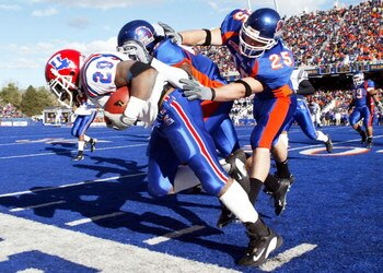BOISE, ID - NOVEMBER 20:  Running back Ryan Moats #20 of Louisiana Tech is pushed out of bounds by Korey Hall #25 of Boise State during the first quarter at Bronco Stadium on November 20, 2004 in Boise, Idaho. Boise State defeated Louisiana Tech 55-14. (P