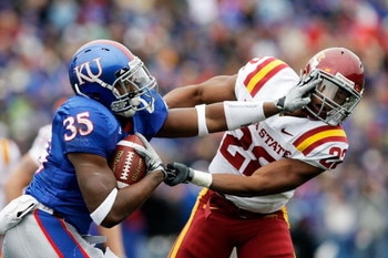 LAWRENCE, KS - OCTOBER 10:  Running back Toben Opurum #35 of the Kansas Jayhawks stiffarms Ter'ran Benton #22 of the Iowa State Cyclones during the game on October 10, 2009 at Memorial Stadium in Lawrence, Kansas.  (Photo by Jamie Squire/Getty Images)