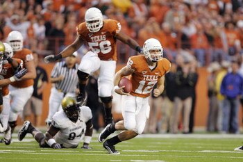 AUSTIN, TX - OCTOBER 10:  Quarterback Colt McCoy #12 of the Texas Longhorns takes off running on a busted play against Nate Bonsu #94 of the Colorado Buffaloes on October 10, 2009 at Darrell K Royal-Texas Memorial Stadium in Austin, Texas.  Texas won 38-1