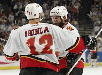 TAMPA, FL - MAY 25: Robyn Regehr #28 of the Calgary Flames congratulates teammate Jarome Iginla #12 after Iginla scored an unassisted shorthanded goal against the Tampa Bay Lightning in game one of the NHL Stanley Cup Finals on May 25, 2004 at the St. Pet