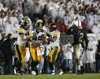 STATE COLLEGE, PA - SEPTEMBER 26:  A.J. Edds #49 of the Iowa Hawkeyes celebrates a fourth quarter interception with Pat Angerer #43 and Jeremiha Hunter #42 in front of Chaz Powell #2 of the Penn State Nittnay Lions  on September 26, 2009 at Beaver Stadium