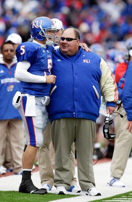 LAWRENCE, KS - OCTOBER 10:  Quarterback Todd Reesing #5 of the Kansas Jayhawks puts his arm around head coach Mark Mangino after rushing for a touchdown during the game against the Iowa State Cyclones on October 10, 2009 at Memorial Stadium in Lawrence, K