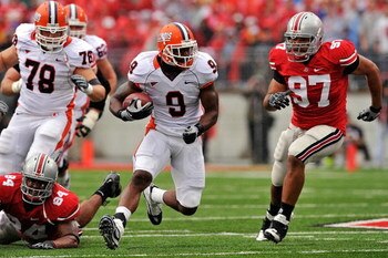 COLUMBUS, OH - SEPTEMBER 26:  Arrelious Benn #9 of the Illinois Fighting Illini looks for running room as Cameron Heyward #97 of the Ohio State Buckeyes closes in at Ohio Stadium on September 26, 2009 in Columbus, Ohio.  (Photo by Jamie Sabau/Getty Images