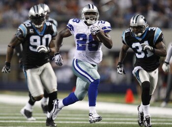 ARLINGTON, TX - SEPTEMBER 28: Felix Jones #28 of the Dallas Cowboys runs the ball 40 yards in the 3rd quarter against Richard Marshall #31 and Julius Peppers #90 of the Carolina Panthers at Cowboys Stadium on September 28, 2009 in Arlington, Texas. (Photo