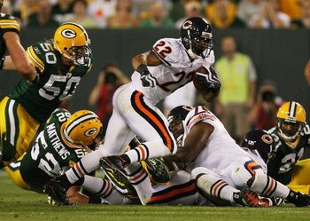 GREEN BAY, WI - SEPTEMBER 13: Matt Forte #22 of the Chicago Bears tries to gain yardage as A.J. Hawk #50 of the Green Bay Packers chases him on September 13, 2009 at Lambeau Field in Green Bay, Wisconsin. The Packers defeated the Bears 21-15.  (Photo by J