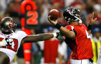 ATLANTA - NOVEMBER 18:  Defensive end Gaines Adams #90 of the Tampa Bay Buccaneers forces a fumble as he grabs the arm of quarterback Byron Leftwich #4 of the Atlanta Falcons during the second half at Georgia Dome on November 18, 2007 in Atlanta, Georgia.