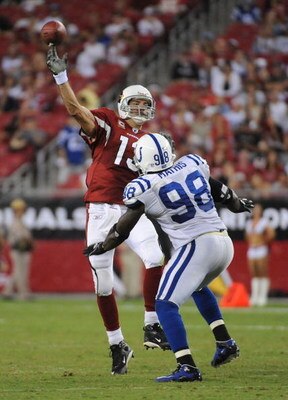 GLENDALE, AZ - SEPTEMBER 27:  Kurt Warner #13 of the Arizona Cardinals  throws as he is rushed by Robert Mathis #98 of the Indianapolis Colts during the game at University of Phoenix Stadium on September 27, 2009 in Glendale, Arizona.  (Photo by Harry How