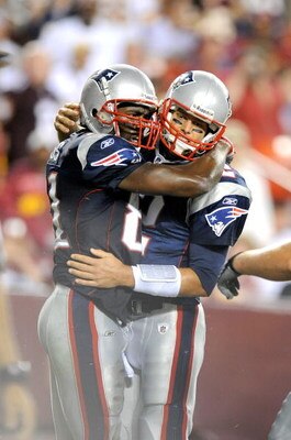 LANDOVER, MD - AUGUST 28:  Tom Brady #12 and Randy Moss #81 of the New England Patriots celebrate after scoring a touchdown in the second quarter of a preseason game against the Washington Redskins at FedExField on August 28, 2009 in Landover, Maryland.  
