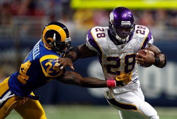 ST. LOUIS - OCTOBER 11:  Running back Adrian Peterson #28 of the Minnesota Vikings runs the ball past Ron Bartell #24 of the St. Louis Rams at Edward Jones Dome on October 11, 2009 in St. Louis, Missouri.  (Photo by Ronald Martinez/Getty Images)