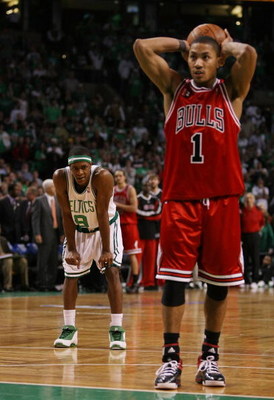 BOSTON - APRIL 18: Rajon Rondo #9 of the Boston Celtics looks on as Derrick Rose #1 of the Chicago Bulls prepares to shoot a free throw in the final minute of overtime in Game One of the Eastern Conference Quarterfinals during the 2009 NBA Playoffs at TD