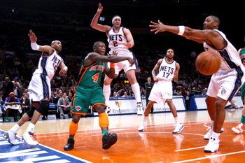 NEW YORK - MARCH 18: Nate Robinson #4 of the New York Knicks gets a pass away under pressure from Vince Carter #15, Josh Boone #2, Chris Douglas-Roberts #17 and Bobby Simmons #21 of the the New Jersey Nets at Madison Square Garden March 18, 2009 in New Yo