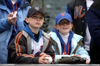 NEW YORK - APRIL 04:  Two young Mets fans watch batting practice before the New York Mets game against the Boston Red Sox on April 4, 2009 at Citi Field in the Flushing neighborhood of the Queens borough of New York City.  (Photo by Ezra Shaw/Getty Images