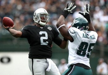OAKLAND, CA - OCTOBER 18:   JaMarcus Russell #2 of the Oakland Raiders passes against Victor Abiamiri #95 of the Philadelphia Eagles during an NFL game at the Oakland-Alameda County Coliseum on October 18, 2009 in Oakland, California. (Photo by Jed Jacobs