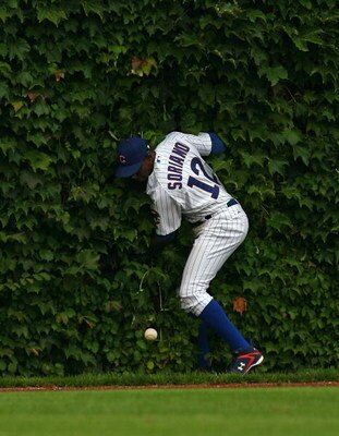 CHICAGO - AUGUST 28: Alfonso Soriano #12 of the Chicago Cubs hits the outfield wall after missing a catch against the New York Mets on August 28, 2009 at Wrigley Field in Chicago, Illinois. The Cubs defeated the Mets 5-2. (Photo by Jonathan Daniel/Getty I