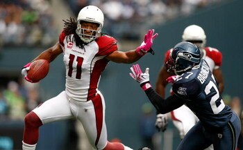 SEATTLE, WA - OCTOBER 18:  Larry Fitzgerald #11 of the Arizona Cardinals breaks a tackle by Jordan Babineaux #27 of the Seattle Seahawks at Qwest Field on October 18, 2009 in Seattle, Washington.  (Photo by Jonathan Ferrey/Getty Images)