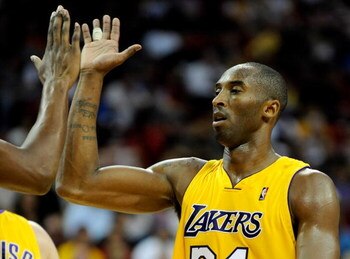 LAS VEGAS - OCTOBER 15:  Kobe Bryant #24 of the Los Angeles Lakers high-fives  Andrew Bynum #17 during their preseason game against the Sacramento Kings at the Thomas & Mack Center October 15, 2009 in Las Vegas, Nevada. NOTE TO USER: User expressly acknow