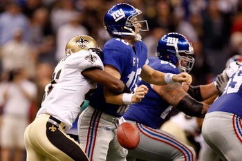 NEW ORLEANS - OCTOBER 18:  Roman Harper #41 of the New Orleans Saints forces a fumble by quarterback Eli Manning #10 of the New York Giants at the Louisiana Superdome on October 18, 2009 in New Orleans, Louisiana.  (Photo by Chris Graythen/Getty Images)