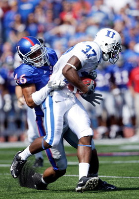 LAWRENCE, KS - SEPTEMBER 19: Johnny Williams #37 of the Duke Blue Devils carries the ball as Justin Thornton #46 of the Kansas Jayhawks defends during the 1st half of the game at Kivisto Field at Memorial Stadium on September 19, 2009 in Lawrence, Kansas