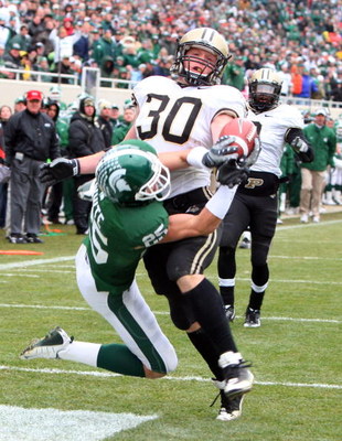 EAST LANSING, MI - NOVEMBER 08: Joe Holland #30 of the Purdue Boilermakers breaks up a pass in the endzone by Blair White #25 of the Michigan State Spartans at Spartan Stadium on November 8, 2008 in East Lansing, Michigan. (Photo by Jim McIsaac/Getty Im