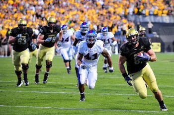 BOULDER, CO - OCTOBER 17:  Rier Geer #87 of the Colorado Buffaloes runs for a touch down against Arist Wright #41 of the Kansas Jayhawks during the game at Folsom Field on October 17, 2009 in Boulder, Colorado. (Photo by Garrett W. Ellwood/Getty Images)