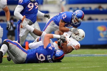 LAWRENCE, KS - NOVEMBER 15:  James Holt #12 and Caleb Blakesley #94 of the Kansas Jayhawks tackle Foswhitt Whittaker #28 of the Texas Longhorns on November 15, 2008 at Memorial Stadium in Lawrence, Kansas.  Texas defeated Kansas 35-7. (Photo by G. Newman 