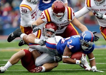 LAWRENCE, KS - OCTOBER 10:  Bradley McDougald #24 of the Kansas Jayhawks is tackled by Michael O'Connell #37 of the Iowa State Cyclones during the game on October 10, 2009 at Memorial Stadium in Lawrence, Kansas.  (Photo by Jamie Squire/Getty Images)