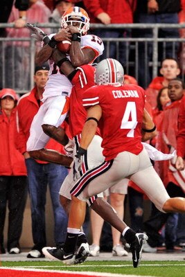 COLUMBUS, OH - SEPTEMBER 26:  Wide receiver Chris Duvalt #15 of the Illinois Fighting Illini hauls in a long pass but is forced out of bounds by Chimdi Chekwa #5 and Kurt Coleman #4 of the Ohio State Buckeyes at Ohio Stadium on September 26, 2009 in Colum
