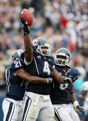 EAST HARTFORD, CT - SEPTEMBER 12:  Twyon Martin #4 of the Connecticut Huskies celebrates his fumble recovery with teammates Gary Wilburn #21 and Jasper Howard #6 in the second half against the North Carolinia Tar Heels on September 12, 2009 at Rentschler 
