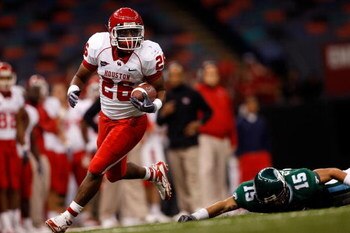 NEW ORLEANS - OCTOBER 17:  Chris Wilson #26 of the Houston Cougars runs past Taylor Echols #15 of the Tulane Green Wave at the Louisiana Superdome on October 17, 2009 in New Orleans, Louisiana. The Cougars defeated the Green Wave 44-16.  (Photo by Chris G