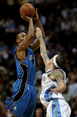 DENVER - JANUARY 17:  Rashard Lewis #9 of the Orlando Magic puts up a shot over the defense of Chris Andersen #11 of the Denver Nuggets during NBA action at the Pepsi Center on January 17, 2009 in Denver, Colorado. The Magic defeated the Nuggets 106-88. N