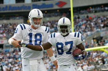 CHARLOTTE, NC - OCTOBER 28:  Peyton Manning #18 of the Indianapolis Colts celebrates with Reggie Wayne #87 after a touchdown pass against the Carolina Panthers during their game at Bank of America Stadium on October 28, 2007 in Charlotte, North Carolina. 