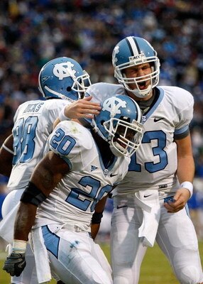 DURHAM, NC - NOVEMBER 29:  Quarterback T.J. Yates #13 of the North Carolina Tar Heels celebrates with running back Shaun Draughn #20 after Draughn's touchdown against the Duke Blue Devils during the game at Wallace Wade Stadium on November 29, 2008 in Dur