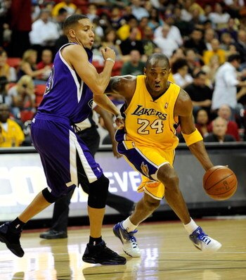 LAS VEGAS - OCTOBER 15:  Kobe Bryant #24 of the Los Angeles Lakers drives around Kevin Martin #23 of the Sacramento Kings during their preseason game at the Thomas & Mack Center October 15, 2009 in Las Vegas, Nevada. NOTE TO USER: User expressly acknowled