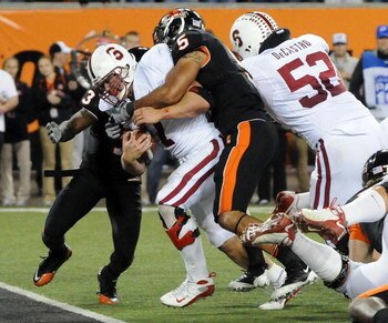 CORVALLIS, OR - OCTOBER 10: Running back Toby Gerhart #7 of the Stanford Cardinals drags safety Cameron Collins #5 of the Oregon State Beavers into the end zone as he scores a touchdown in the fourth quarter of the game at Reser Stadium on October 10, 200