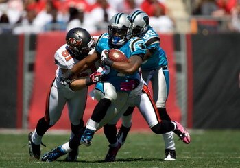TAMPA, FL - OCTOBER 18:  Running back DeAngelo Williams #34 of the Carolina Panthers is tackled by defenders Barrett Ruud #51 and Ronde Barber #20 of the Tampa Bay Buccaneers during the game at Raymond James Stadium on October 18, 2009 in Tampa, Florida. 