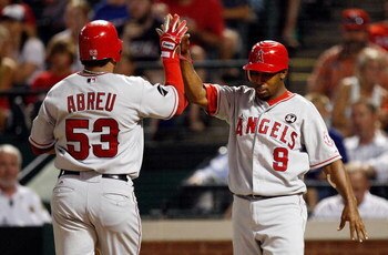 ARLINGTON, TX - JULY 1:  Bobby Abreu #53 and Chone Figgins #9 of the Los Angeles Angels of Anaheim celebrate after scoring against the Texas Rangers in the seventh inning at Rangers Ballpark July 1, 2009 in Arlington, Texas.  (Photo by Ronald Martinez/Get