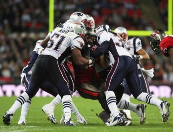 LONDON, ENGLAND - OCTOBER 25:  Kellen Winslow (#82)of Tampa Bay Buccaneers is tackled by the New England Patriots defence during the NFL International Series match between New England Patriots and Tampa Bay Buccaneers at Wembley Stadium on October 25, 200