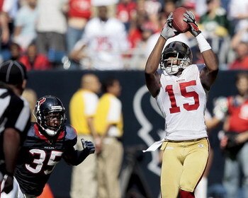 HOUSTON - OCTOBER 25:  Wide receiver Michael Crabtree #15 of the San Francisco 49ers catches a pass in the fourth quarter in front of cornerback Jacque Reeves #35 of the Houston Texans at Reliant Stadium on October 25, 2009 in Houston, Texas.  (Photo by B