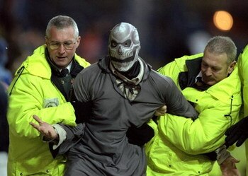 6 Nov 1999:  Halloween intruder is led away by stewards during the FA Carling Premiership match between Sheffield Wednesday and Watford at Hillsborough in Sheffield, England. \ Mandatory Credit: Mark Thompson /Allsport