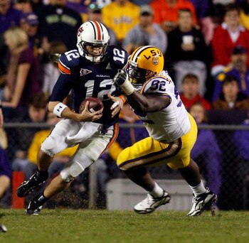 BATON ROUGE, LA - OCTOBER 24:  Quarterback Chris Todd #12 of the Auburn Tigers is sacked by Drake Nevis #92 of the Louisiana State University Tigers at Tiger Stadium on October 24, 2009 in Baton Rouge, Louisiana.  (Photo by Chris Graythen/Getty Images)