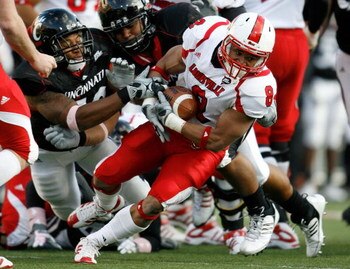 CINCINNATI - OCTOBER 24:  Darius Ashley #8 of the Louisville Cardinals is tackled by the Cincinnati Bearcats defense during the Big East Conference game at Nippert Stadium on October 24, 2009 in Cincinnati, Ohio.  (Photo by Andy Lyons/Getty Images)