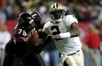 ATLANTA - DECEMBER 12:  Aaron Brooks #2 of the New Orleans Saints is chased from behind by Rod Coleman #75 of the Atlanta Falcons in NFL action December 12, 2005 at the Georgia Dome in Atlanta, Georgia.  (Photo By Streeter Lecka)