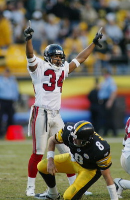 PITTSBURGH, PA - NOVEMBER 10: Cornerback Ray Buchanan #34 of the Atlanta Falcons celebrates as quarterback Tommy Maddox #8 of the Pittsburgh Steelers picks himself up off the ground on November 10, 2002 at Heinz Field in Pittsburgh, Pennsylvania. The gam