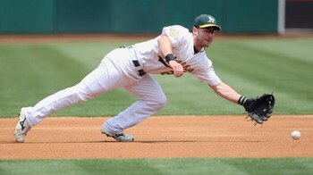 OAKLAND - JULY 10:  Jack Hannahan #22 of the Oakland Athletics leaps for the ball against the Seattle Mariners during a Major League Baseball game on July 10, 2008 at McAfee Coliseum in Oakland, California. (Photo by: Jed Jacobsohn/Getty Images)