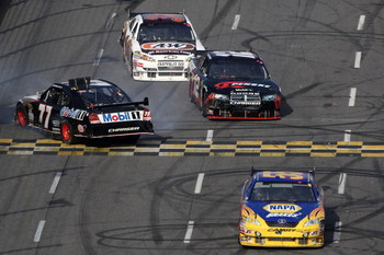 MARTINSVILLE, VA - OCTOBER 25: Michael Waltrip, driver of the #55 NAPA Adaptive One Brakes Toyota, David Stremme, driver of the #12 Penske Dodge, and John Andretti, driver of the #34 A&W All American Hamburger Chevrolet, pass by Sam Hornish Jr., driver o