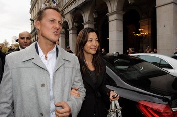 PARIS - OCTOBER 23:  Michael Schumacher (L) and Michele Yeoh (R) leave the Westin Hotel after Jean Todt was elected president of Inernational Automobile Federation (FIA) on October 23, 2009 in Paris, France.  (Photo by Pascal Le Segretain/Getty Images)